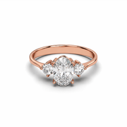 Three Stone Oval Lab-Grown Diamond Ring with Round Side Stones in Rose Gold Front View